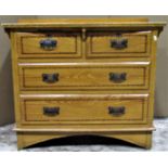 A low Edwardian pine bedroom chest of two short over two long drawers with simulated wood grained