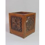 An Arts & Crafts oak planter of square cut form with exposed dovetail construction and carved floral