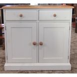 A contemporary Victorian style pine side cupboard with partially painted finish enclosed by a pair