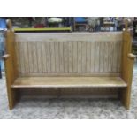 A stripped pine pew with moulded outline and tongue and groove panelled back, 200 cm long x 143 cm