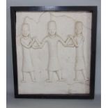 Tribal Interest - An unusual plaster panel of three tribesmen, within a black ebonised frame, 46 x