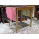 A Kandya 1950s drop leaf kitchen table with formica top raised on splayed beechwood supports, the