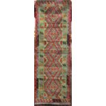 A flat weave Kelim rug with multi coloured geometric detail, 185cm x 65cm