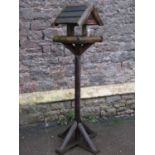 A rustic freestanding garden bird table, 150 cm high