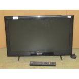 A Sony Bravia flatscreen LCD television model number KDL-22EX553 with remote control, together
