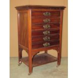An Edwardian walnut floorstanding sheet music cabinet of five long drawers with patent fall