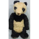 Early 1930's Merrythought giant panda, with stitched nose, leather claws, glass eyes, (worn fur on