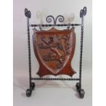 A good quality Arts & Crafts style firescreen, the iron work frame with twisted and scrolled