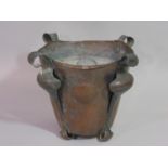 An Arts & Crafts copper jardiniere with hammered scrolling foliate supports stamped to base, 22 cm