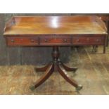 An unusual mid Victorian mahogany writing table of rectangular form with three quarter gallery