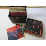 A carrying case containing a quantity of 45rpm vinyl singles dating from the late 70s and the 1980s,