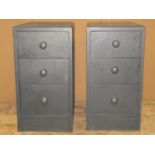 A pair of low oak three drawer pedestal bedside chests with turned knob handles and painted