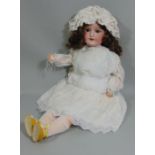 CM Bergmann Waltershausen bisque socket headed doll, with fixed brown eyes, open mouth with top