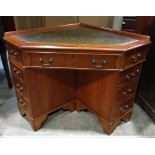 A reproduction Georgian style yewwood veneered twin pedestal corner desk with inset green leather