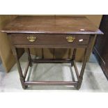 An antique oak side table with rectangular moulded top over a frieze drawer raised on slender turned