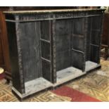 A Victorian dark stained oak dwarf freestanding open bookcase with carved detail, shallow breakfront