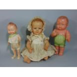3 early celluloid dolls including a French Petitcollin baby doll with bent limbs, period silk