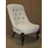 A Victorian nursing chair, simply upholstered in white calico and raised on scrolled cabriole