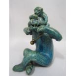 An unusual 19th century ceramic model of a seated monkey with its young with all over turquoise