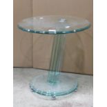 A small modernist glass occasional table of circular form with moulded outline and angular column