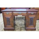 An Edwardian walnut kneehole desk/dressing table with associated top over three frieze drawers and