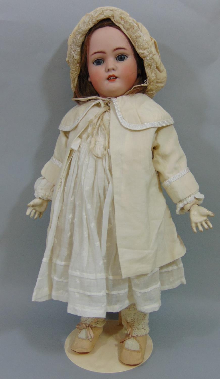 Doll by Simon & Halbig with bisque socket head with jointed pale coloured composition body. weighted