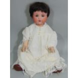1920's Armand Marseille Baby Doll with bisque socket head and composition body with bent limbs. Blue