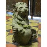 A small antique weathered carved sandstone lion finial clutching a shield, 32 cm in height