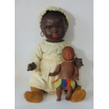 A pair of Ernst Heubach black baby dolls, both mold 399 with painted features, pierced ears and 5