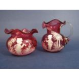 Mary Gregory type cranberry glass jug and bowl with overlay of a boy playing a horn, the jug 10 cm
