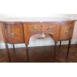 A Georgian mahogany breakfront sideboard, the central frieze drawer flanked by a cellarette and