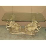 A vintage novel plaster occasional table in the form of four rearing/galloping horses beneath a