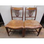 A set of six Regency period mahogany dining chairs with carved and pierced lyre shaped splats within