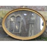 An oval gilt framed wall mirror, the moulded frame with bead and further detail, 74 cm x 53 cm