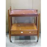 A vintage teak two tier tea trolley with removable tray top, the lower tier incorporating a