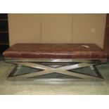 A good quality modernist stool of rectangular form with buttoned tan leather upholstered seat raised