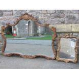 A wall mirror, the composite frame with scrolling acanthus and shell detail, 117 cm wide x 90 cm