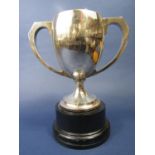 Silver twin handled trophy upon a turned black ebonised wooden plinth inscribed 'The James Walker