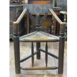 Antique turners chair of usual form with triangular panelled seat, bobbin moulded support and carved