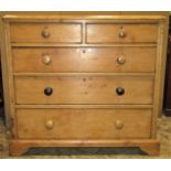 A 19th century stripped pine bedroom chest of two short over three long graduated drawers with