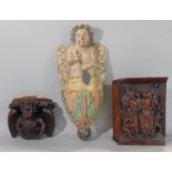 Unusual and carved oak wall bracket in the form of a grumpy angel with a crown around its waist,