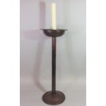 Possibly Goberg, an Arts & Crafts steel candle stand with simple cylindrical stem and domed disc