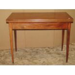 A Georgian mahogany fold over top tea table of rectangular form with inlaid detail and slender