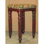 A 19th century mahogany stool with square upholstered seat raised on four turned and reeded legs