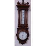 Architectural oak barometer/thermometer, with carved pediment and barometer flanked by turned