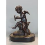 19th century French cast bronze study of a seated cherub, indistinctly signed, oval plinth, black