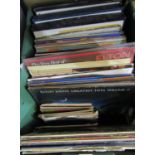 A box containing a mixed collection of vinyl LPs and 45rpm singles - various genres, including 70s/