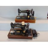 Two vintage cast iron Singer sewing machines