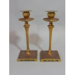 In the manner of W A S Benson, a pair of good quality brass candlesticks with tapered faceted