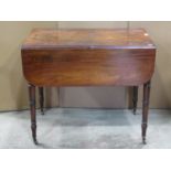 A Regency mahogany Pembroke table fitted with the usual arrangement of one real and one dummy frieze